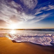 Waves on the beach as the sun sets